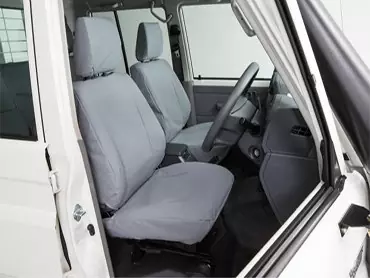 Grey canvas seat covers in a work vehicle