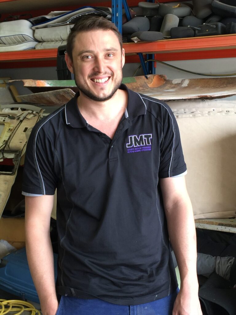 A member of the John's Motor Trimmers team