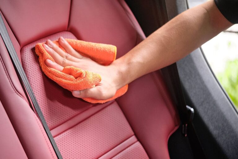Red leather car seat being finished